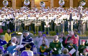 International marching band greets Olympic torch relay